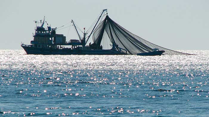 EXPANDING: The next frontier in sprawl may be on the high seas, where the proliferation of fishing, shipping, tourism, resource extraction, energy development, military exercises and other human activity has begun to call into question just how vast our oceans really are. Pictured:a fishing trawler on the high seas. (Photo courtesy Jon Anderson/Flickr)