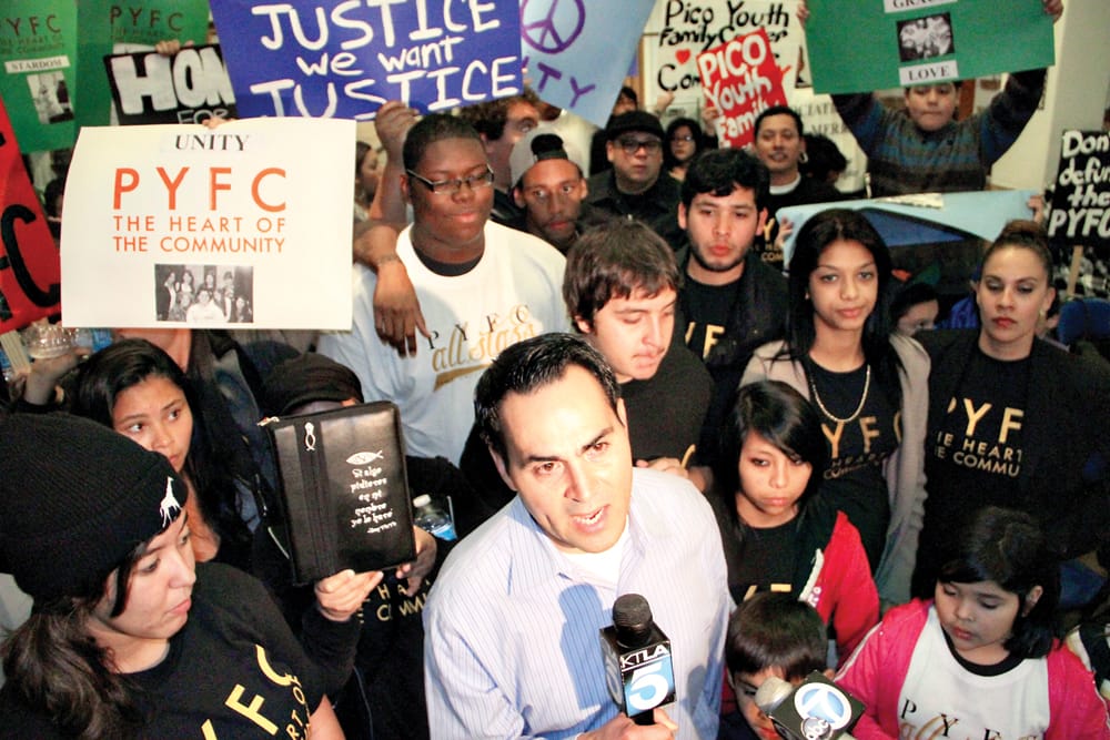 Pico Youth & Family Center founder Oscar de la Torre speaks to newscrews Tuesday amid a group of protestors asking the City Council to continue funding for the embattled center. (Daniel Archuleta daniela@www.smdp.com)