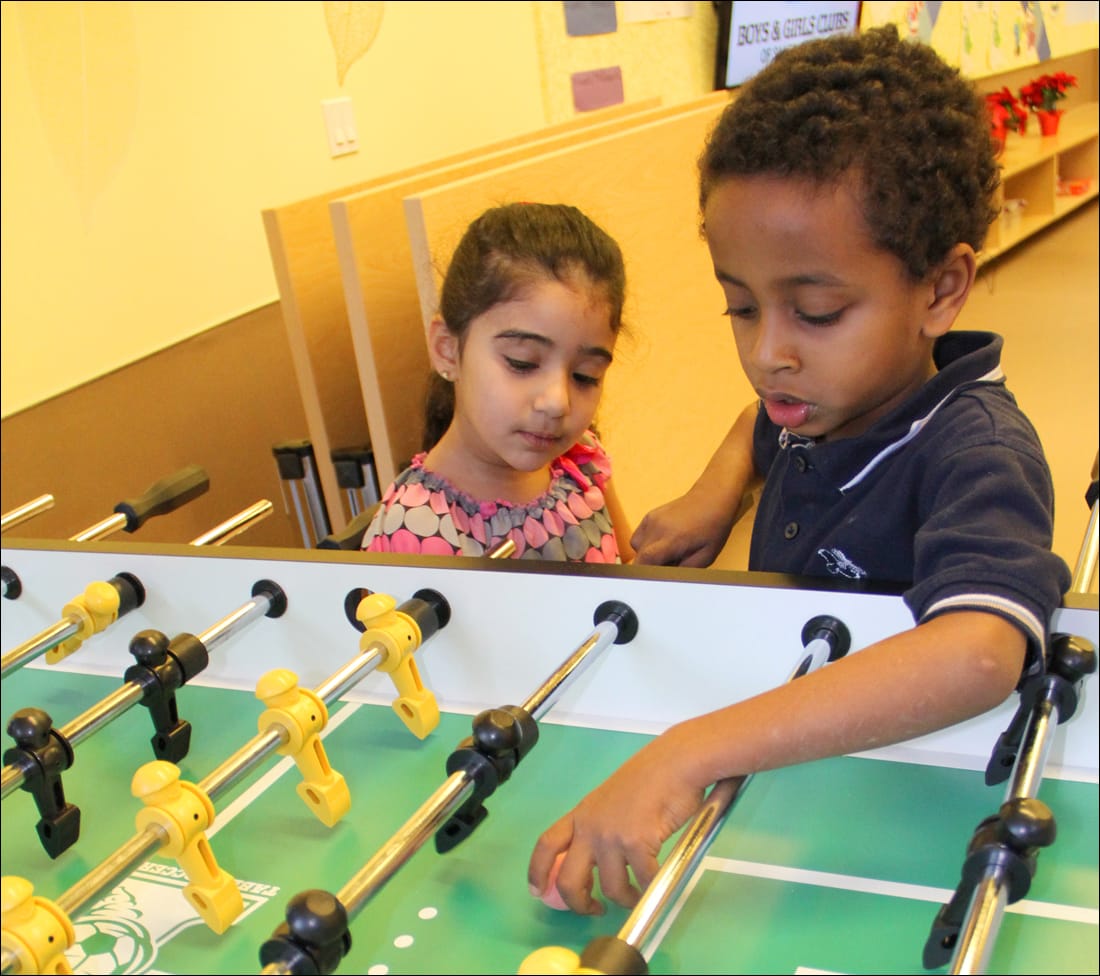 GAME ON: A pair of kids play foosball during the opening in December of a Boys & Girls Clubs of Santa Monica branch in a Community Corp. of Santa Monica building on Broadway. (Photo by Daniel Archuleta)
