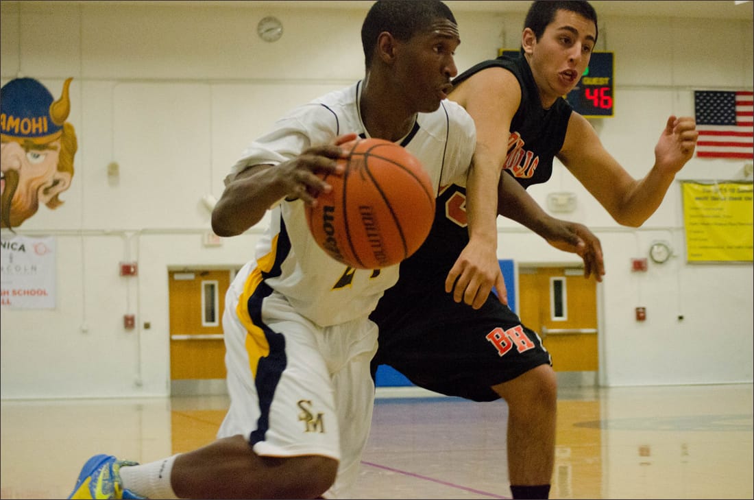 DOING WORK: Samohi's Jordan Mathews dribbles past a Beverly Hills defender on Wednesday at home. Samohi would go on to win, 63-62. (Photo by Paul Alvarez Jr.)