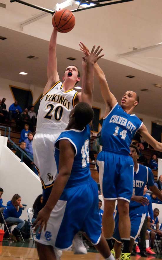 UP HE GOES: Samohi's Tim Southam goes up for a shot against a pair of Culver City defenders on Wednesday on campus. Samohi went on to win, 68-55. (Morgan Genser editor@www.smdp.com)