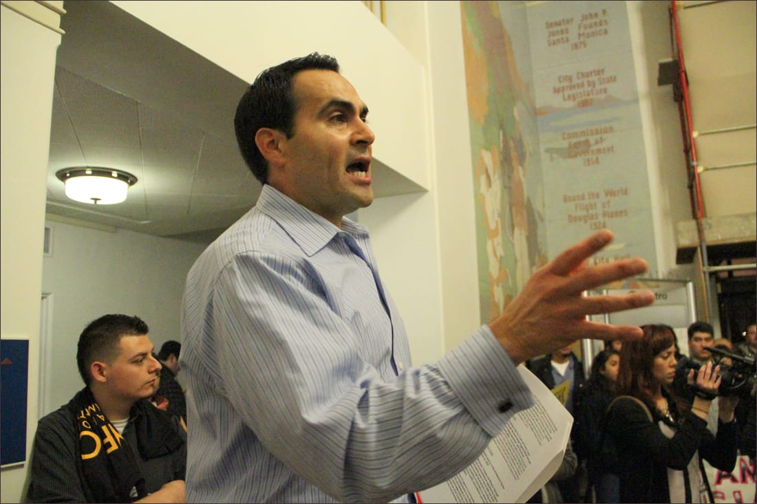 THE SCENE: Pico Youth & Family Center Executive Director Oscar de la Torre speaks to supporters during a rally at City Hall last month. The crowd gathered to speak during a council meeting. (Photo by Daniel Archuleta)