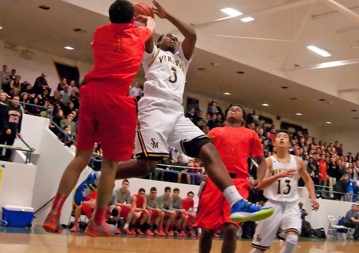 MAKING A GO OF IT: Santa Monica High School's Mikhail Brown attempts a shot against Beverly Hills on Friday at home. Beverly Hills walked away with the win, 58-45, and seized control of first place in the Ocean League in the process. (Morgan Genser editor@www.smdp.com)