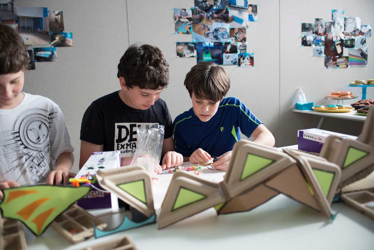 Kids at an open house for Digital Dragon, which provides after-school programs with a tech focus, are hard at work building a circuit board. Digital Dragon's creators, Santa Monica parents Laurie Kantor Finn and her husband, Seth Finn, saw a need for after-school programs that cater to young geeks. (Photo courtesy Digital Dragon)