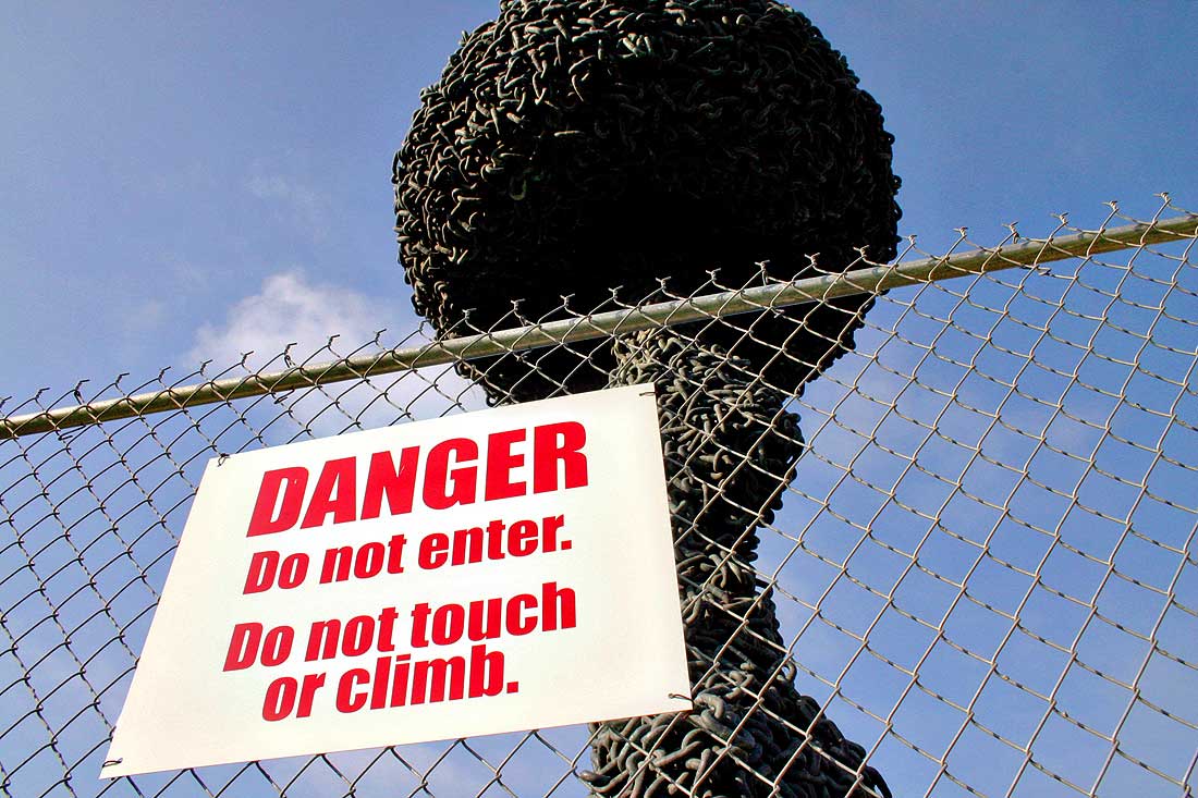 A sign instructs the public to avoid the 'Chain Reaction' sculpture. (File photo)