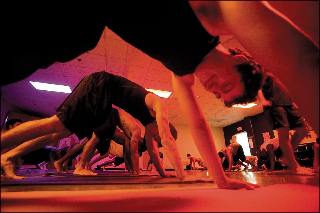 The Santa Monica High School football team goes through an intensive yoga workout with instructor Jason Battung in 2010. (File photo)