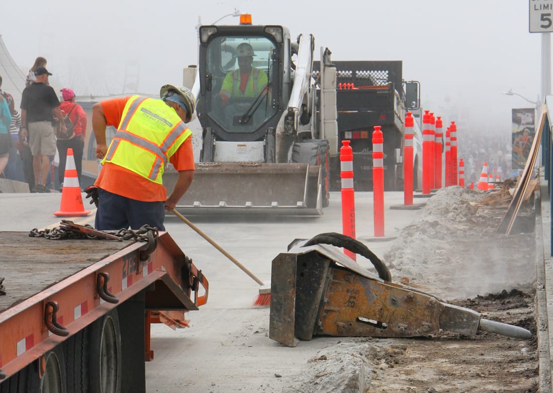 A crew works on a new pedestrian path Tuesday on the bridge that connects the Santa Monica Pier and Ocean Avenue. The project will create one path for pedestrians. (Photo by Daniel Archuleta)
