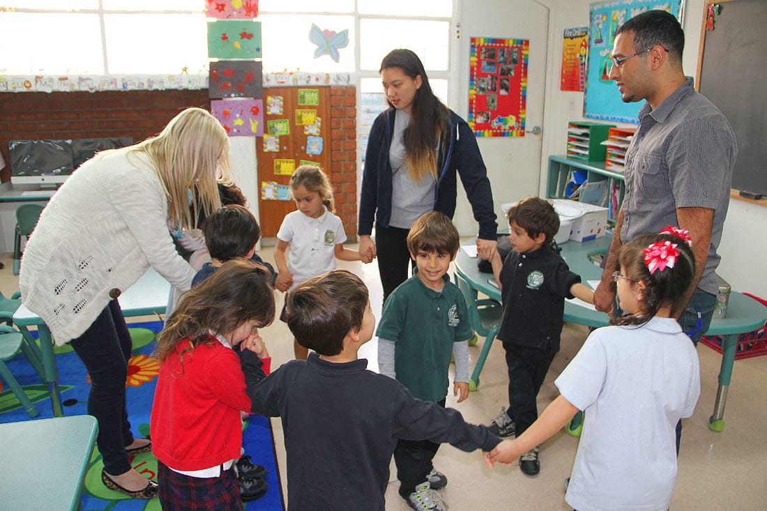 Elementary school students at the Delphi Academy on Fourth Street pretend to be an electric pencil sharpener as part of a spring break project in which college students educate youngsters about energy usage and sustainability. (Photo by Kevin Herrera)