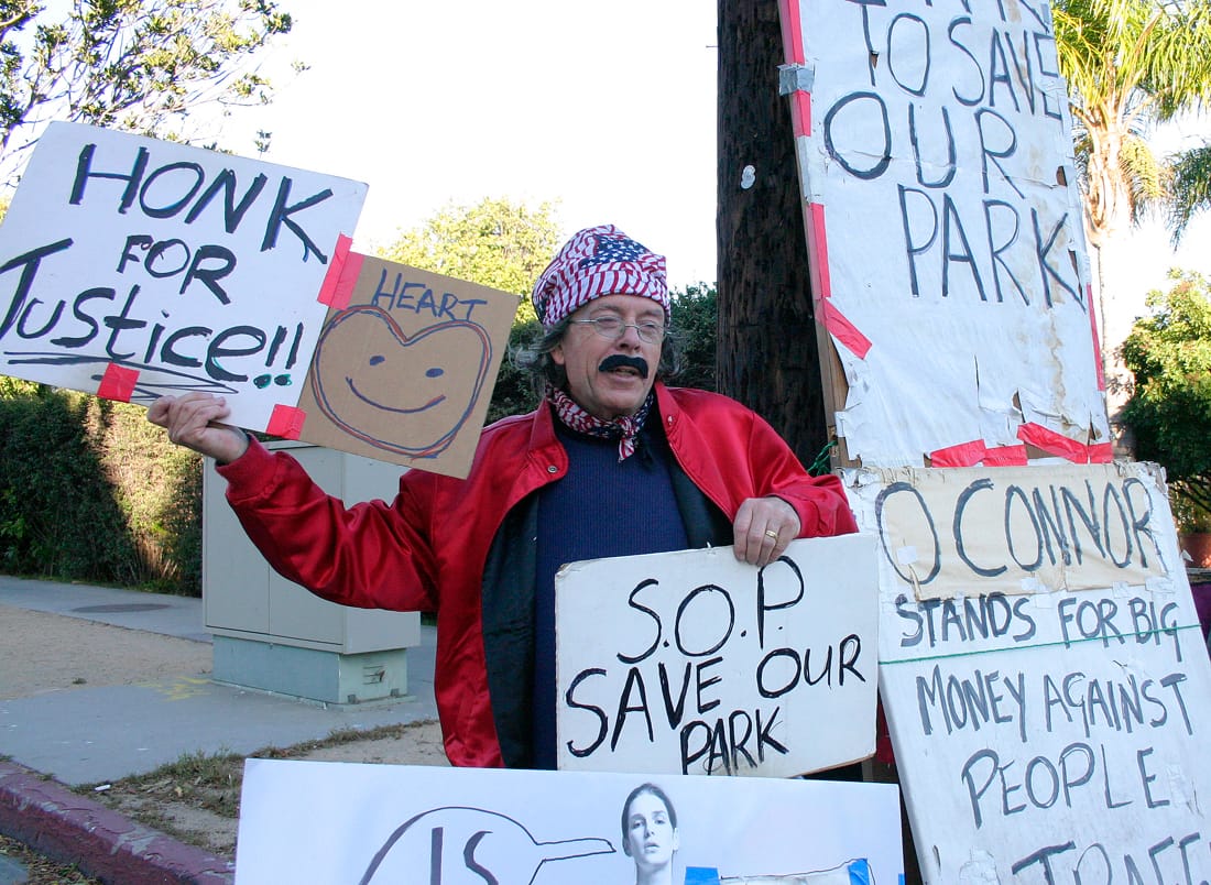 Village Trailer Park resident Peter Naughton protests the closure of the park on Wednesday. (Photo by Daniel Archuleta)