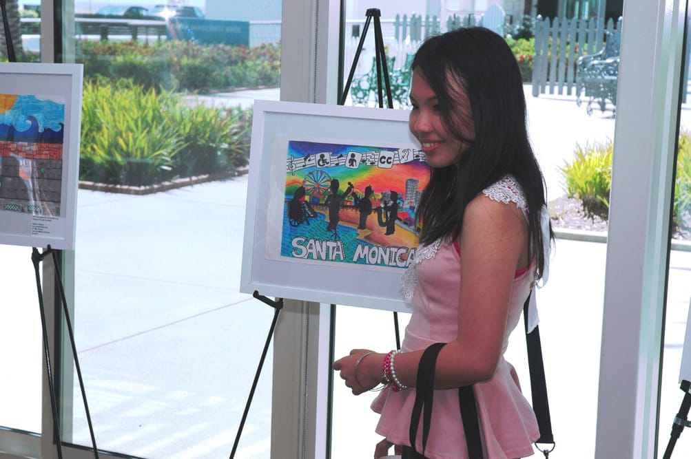 Samohi student Natthavadee Laoharangsima stands next to her award-winning poster. She and other local students participated in the fifth annual Sustainable Santa Monica Student Poster Contest, which focused on those with disabilities and how they enjoy nature with their family and friends.  (Photo courtesy city of Santa Monica)