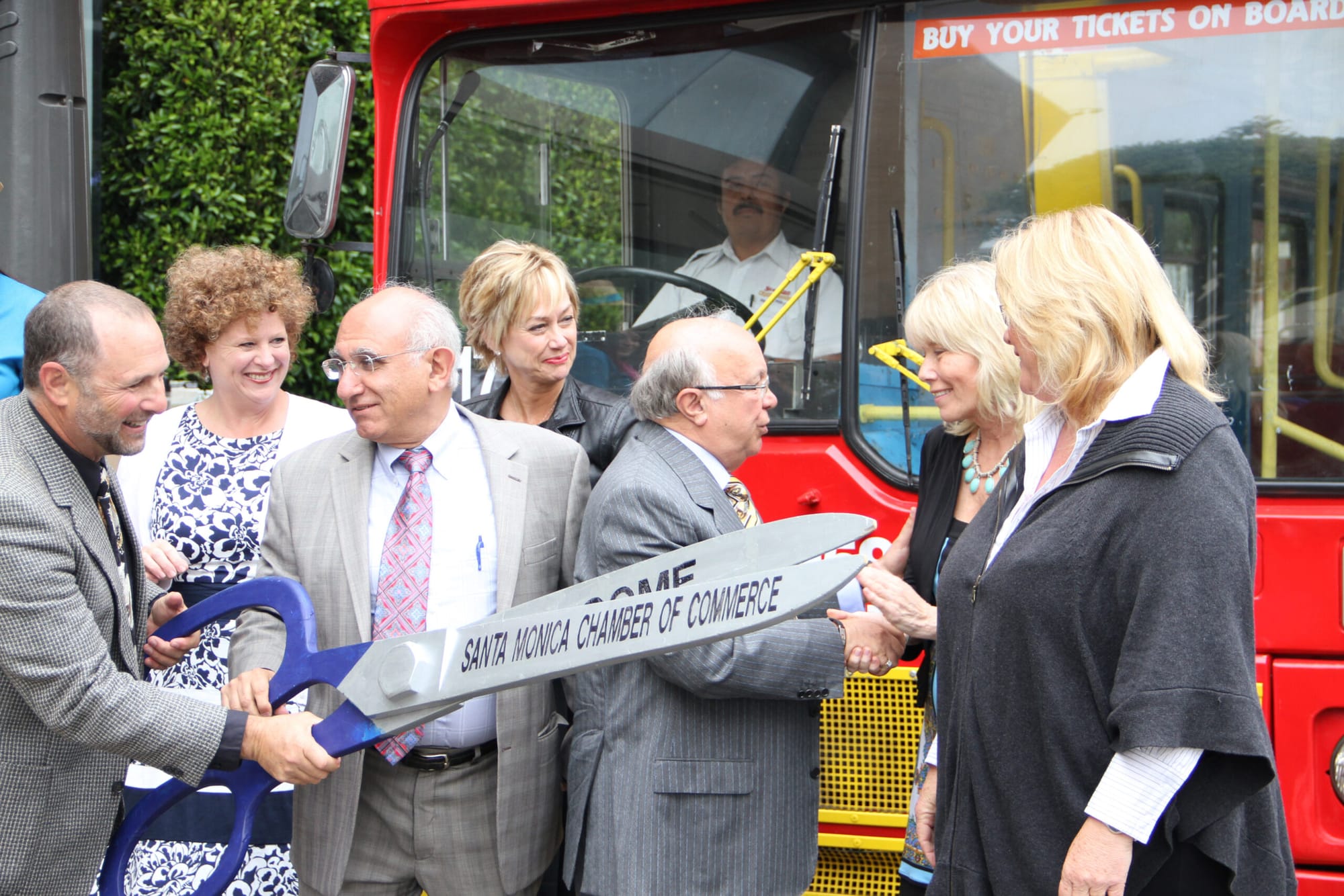 Business leaders celebrate the arrival of a new Starline Tours service that will shuttle tourists from LAX-area hotels to Santa Monica. (Kevin Herrera kevinh@www.smdp.com)