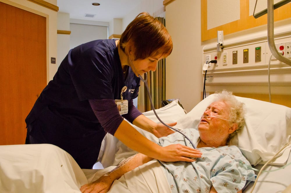 Nurse Sarah Nunn attends to patient Sister Rita Callanan at Santa Monica-UCLA Medical Center on Friday. (Photo by Paul Alvarez Jr.)