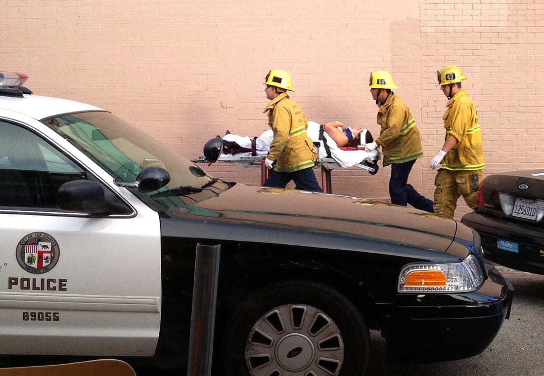 Fire personnel whisk a victim away from the scene of a deadly car crash on the Venice boardwalk. (File photo)