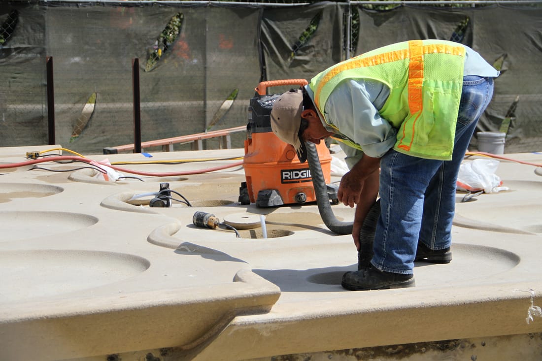 CLOSER LOOK: A crew works on the fountain at Ken Genser Square in front of City Hall on Tuesday. The park is slated to open in October. (Daniel Archuleta daniela@www.smdp.com)