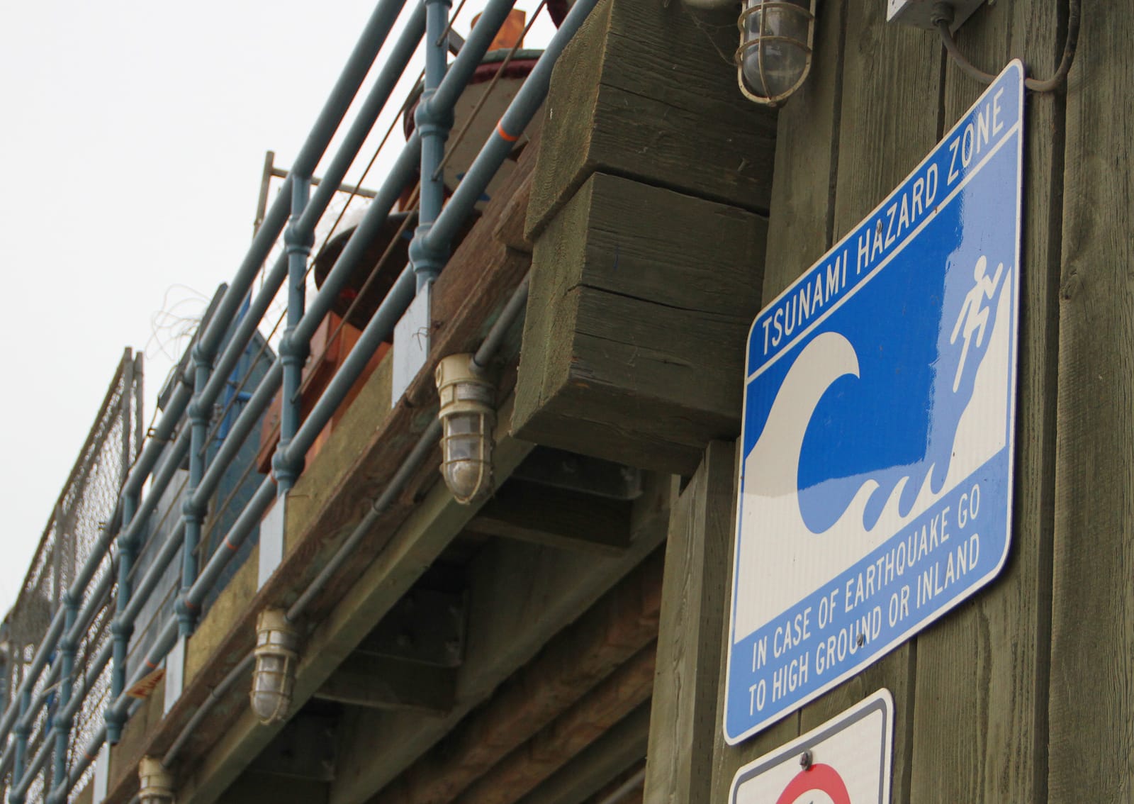 Tsunami warning signs are posted along the Santa Monica Pier. They tell the public to flee to higher ground if large waves approach the shoreline. (Daniel Archuleta daniela@www.smdp.com)