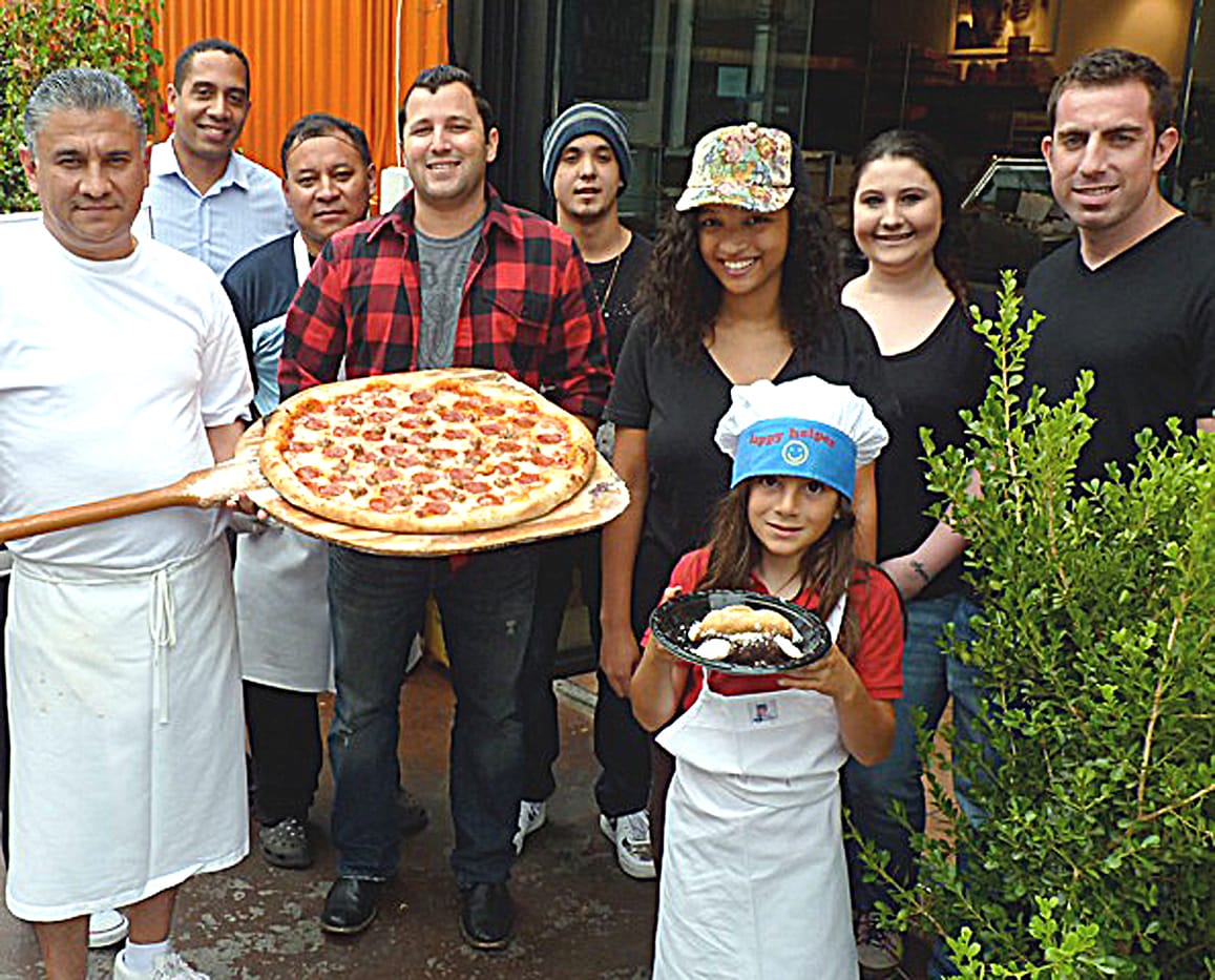 ANYONE HUNGRY? The staff of Bravissimo Caf√© and Pizzeria on Main Street, including Jett, age 8. (Photo courtesy Bruno Marcotulli)  