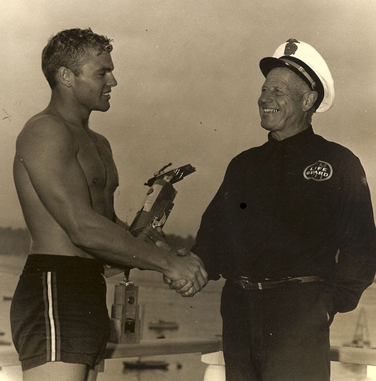 George 'Cap' Watkins (right) presents his friend Tom Zahn with a paddleboarding trophy. Zahn used to bring his girlfriend, Marilyn Monroe, to parties at Cypress Sea Cove, Watkins' idyllic Malibu retreat. (Photo courtesy Richard Mark)