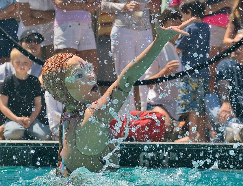 SPLISH SPLASH: Crowds of spectators watch the Cirque Du Soleil O-Show synchronized swimming team on opening day of the Annenberg Community Beach House. (File photo)