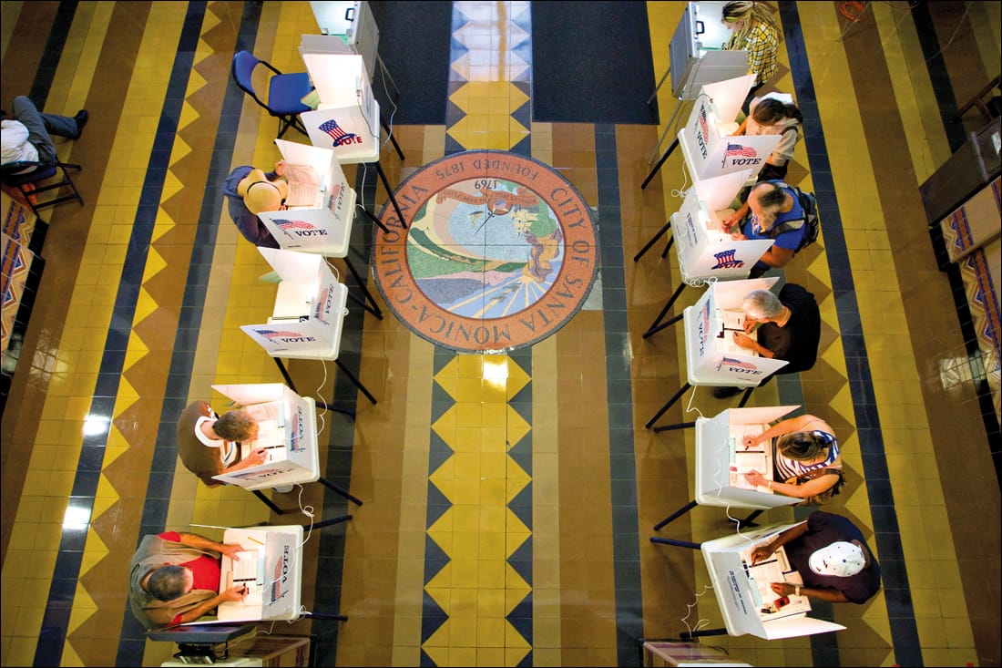 People fill the voting booths at City Hall on Tuesday.