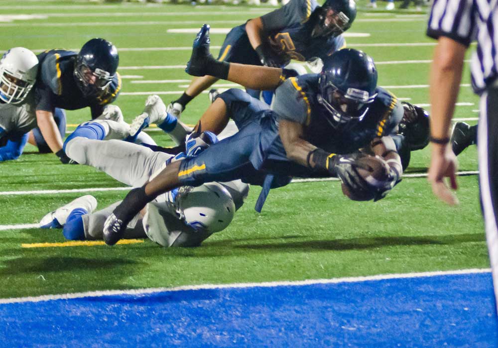REACHING: Samohi's Kwame Duggins dives in for a touchdown against Culver City last week. (Paul Alvarez Jr. editor@www.smdp.com)