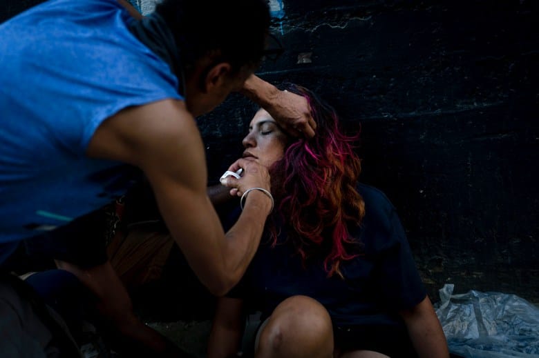 A homeless man injects a Narcan nasal spray into the nose of a female addict who appears to be overdosed in Los Angeles on Aug. 25, 2022.Photo by Jae C. Hong, AP Photo
