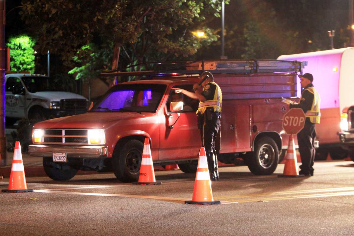 Santa Monica Police officers conduct a DUI checkpoint near Virginia Avenue Park last year. They'll have another one this Friday somewhere in the city. (File photo)
