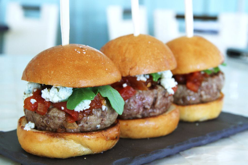 Chef Sven Mede's wagyu beef sliders are featured on a revamped  lounge menu at Casa del Mar. Wash them down with a barrel-aged cocktail.
