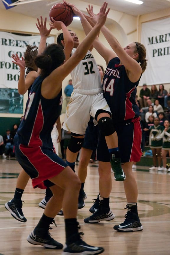 St. Monica's Katrina Balatico drives in between several St. Paul defenders Tuesday night as the teams battled it out for best in league. The Mariners lost 53-49 for a 4-2 record in league and 18-6 overall. (Morgan Genser editor@www.smdp.com)